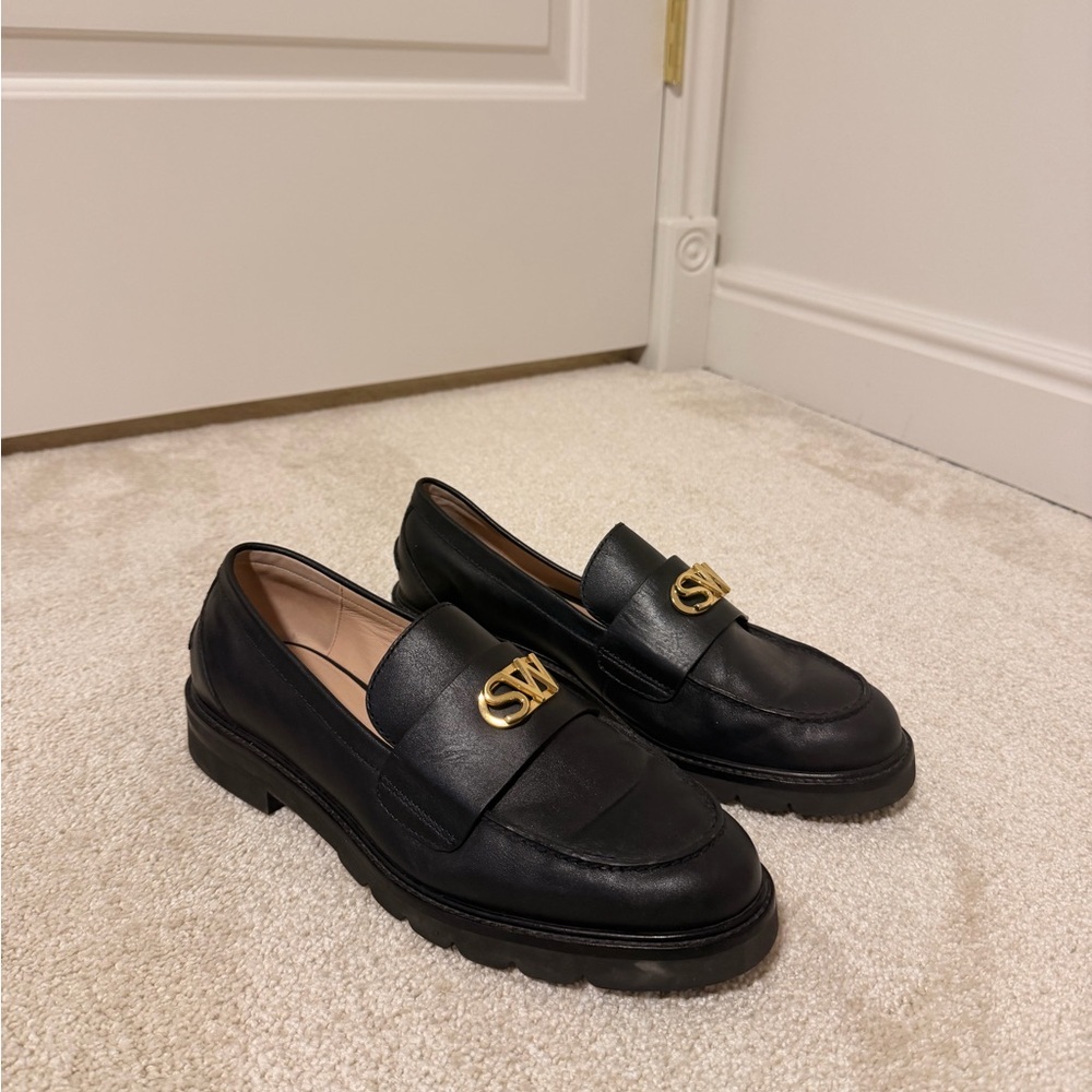 Stuart Weitzman Black Flats with Gold Emblem